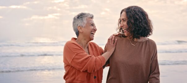 Making the menopause a positive experience. Two senior women at the beach enjoying a walk.
