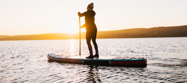 CoQ10 blog | Woman paddleboarding in the morning