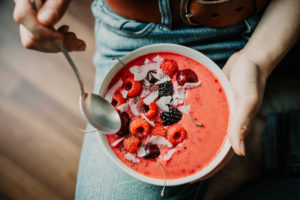 Woman eating healthy smoothie bowl