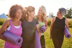 Group Of Mature Female Friends Building Healthy Habits On a Yoga Retreat